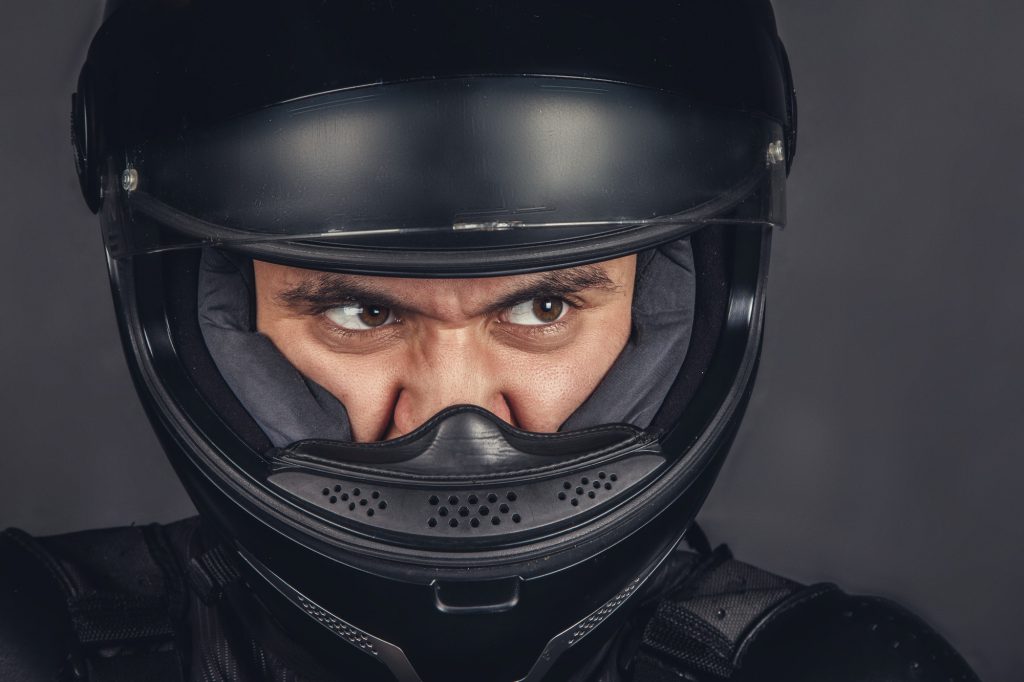 Close up view biker's face in helmet.