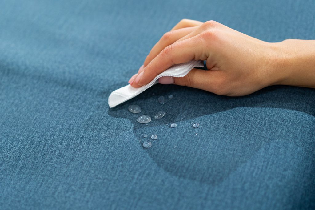 Water drops on waterproof textile material - short depth of field. Waterproof fabric on sofa