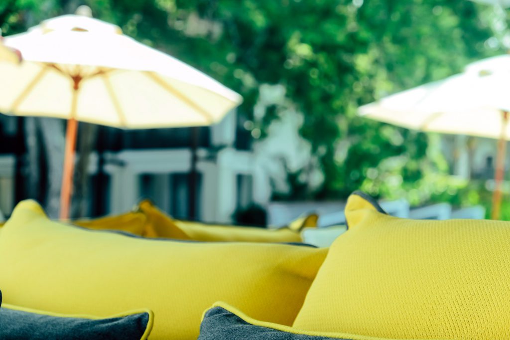 yellow fabric sofa and cushions decorate in tropical resort